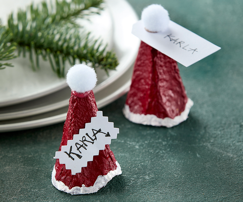 bordkort af toppe fra æggebakken pyntet som nissehuer